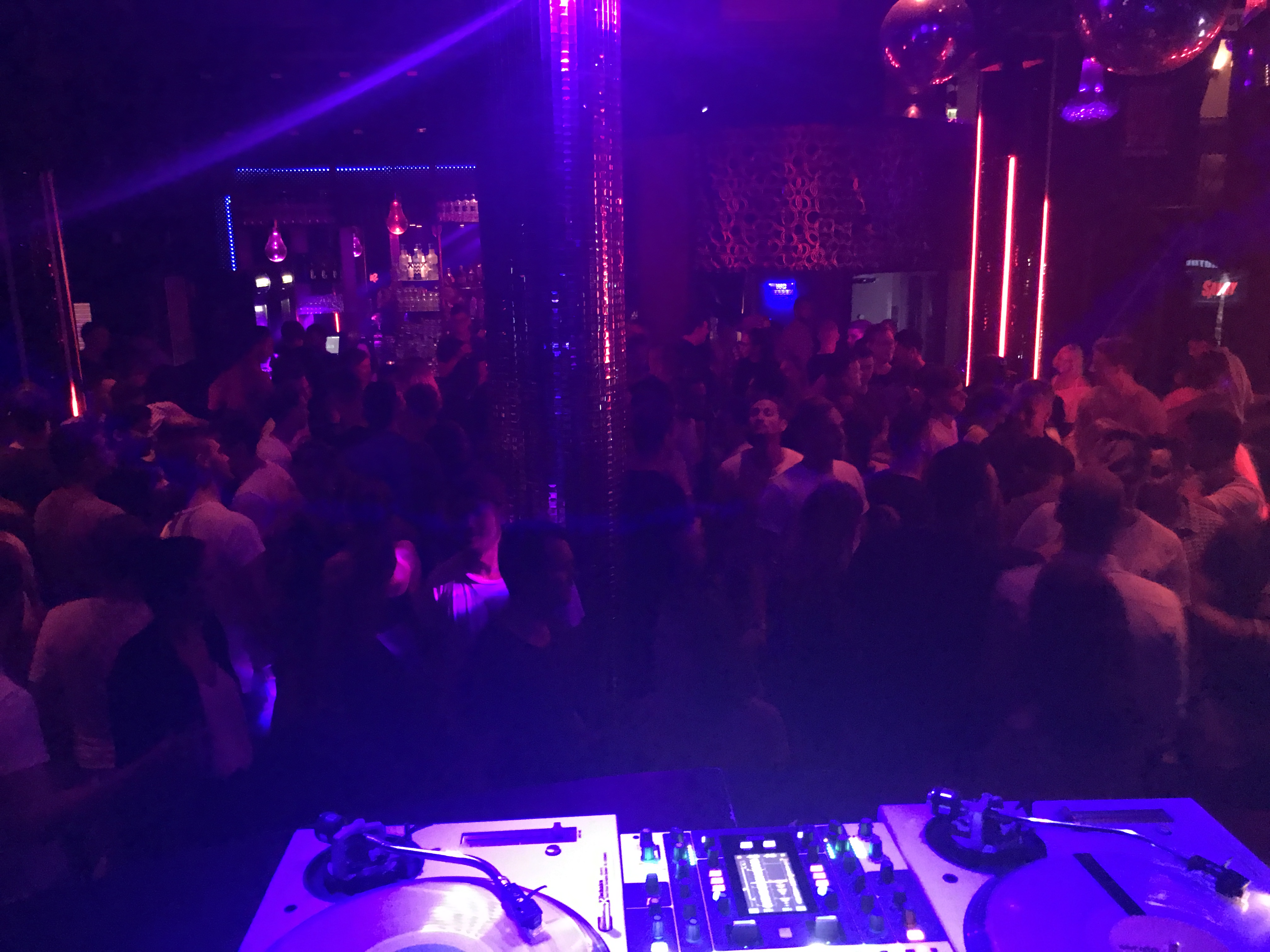 Blick vom DJ-Pult auf eine beleuchtete Tanzfläche